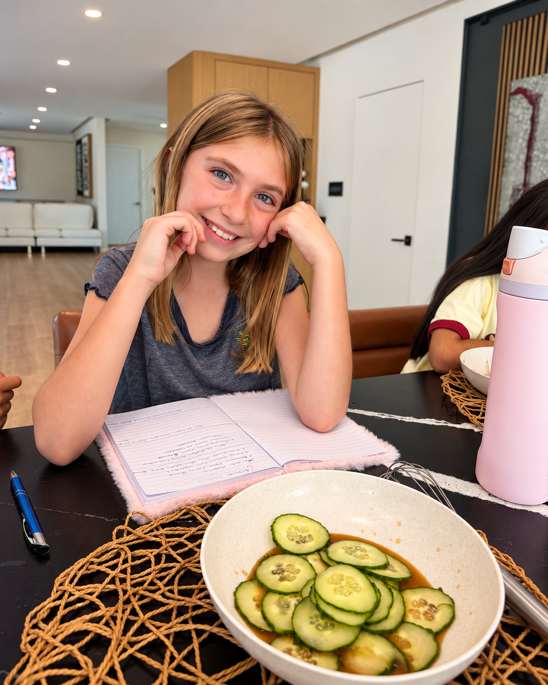Young cook with a bowl of cucumber salad